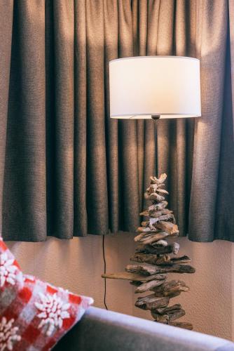 a lamp sitting on a table with a rock christmas tree at Landhaus Perktold in Nesselwängle