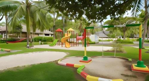 a park with a playground with a slide at Tanjung Lesung Beach Hotel in Carita