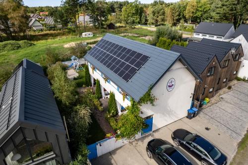 an overhead view of a house with solar panels on the roof at Domki Kurka Wodna in Dębki