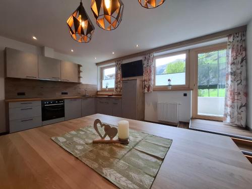 a kitchen with a table with a candle on it at Ferienwohnungen Kirchler in Vorderlanersbach