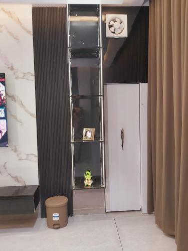 a room with a white refrigerator and a window at Hotel Crystal Sarovar in Mirzāpur