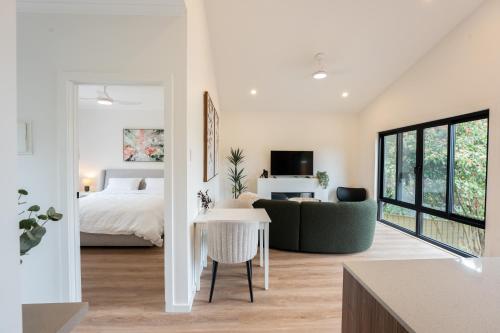 a room with a bed and a couch and a table at Moritz Hahndorf Boutique Guest House in Hahndorf