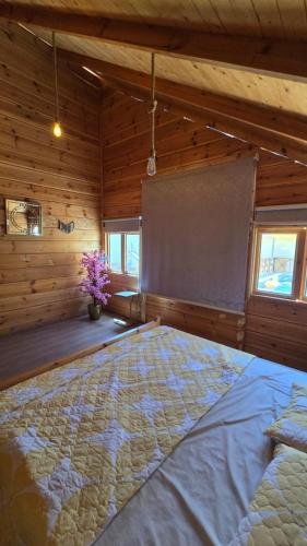 a bedroom with a bed in a room with wooden walls at شاليهات روزڤيو الريفيه Roseview chalets in Taif