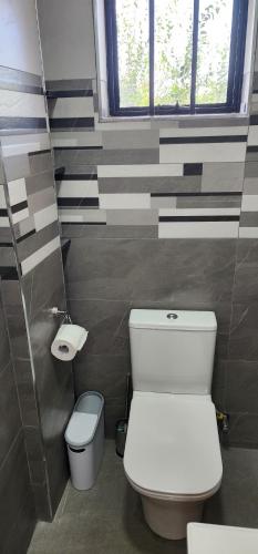 a bathroom with a toilet and a sink at The Lantern Gardens - Oloirien in Kiserian