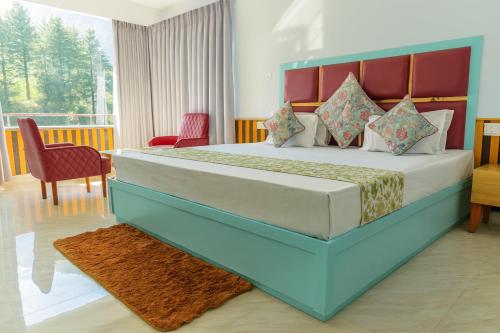 a bedroom with a large bed and a table and chairs at Apple Flower Himalayan Heights - Luxury Stay with Mountain Views, Parking & Garden in Manāli