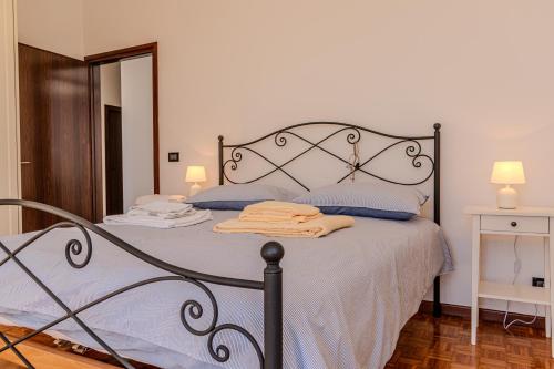 a bedroom with a bed with blue sheets and a mirror at Road to Venice M&N Dolo Apartment in Dolo