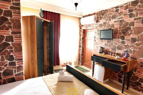 a hotel room with a brick wall at Cappadocia Hostel in Goreme