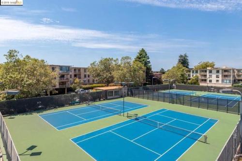 a tennis court with two tennis courts at Modern Bayview Apartment by the Water in Emeryville