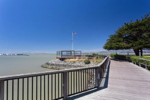 a wooden boardwalk next to a body of water at Modern Bayview Apartment by the Water in Emeryville