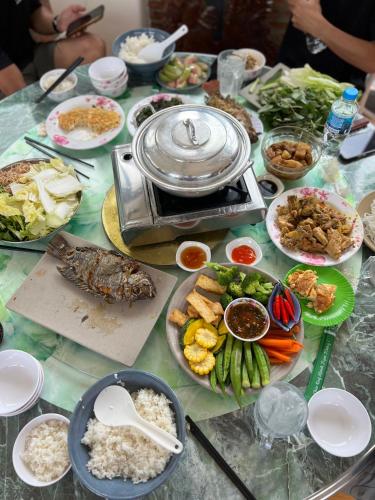 a table topped with plates of food on top at Kala view homestay in Di Linh