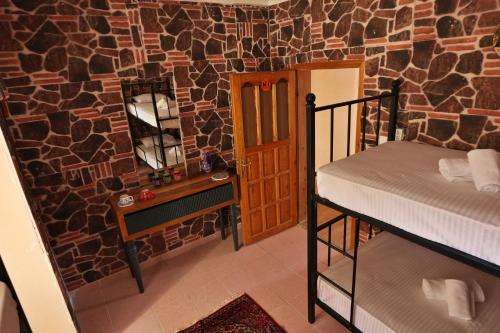 a room with a bedroom with a bed and a mirror at Cappadocia Hostel in Goreme