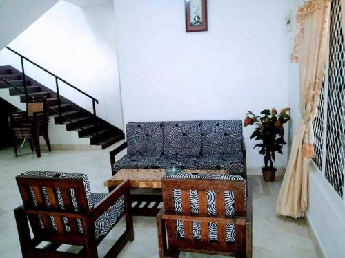a living room with a couch and two chairs at Elkaduwa Bungalow in Elkaduwa
