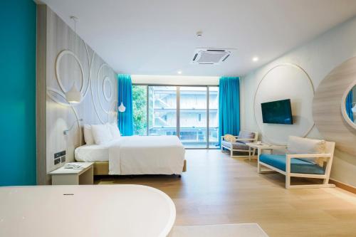 a bedroom with a bed and a desk and a chair at The Waters Khao Lak by Katathani - SHA Extra Plus in Khao Lak