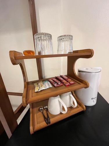 a wooden shelf with glasses and a toilet at Coconut Hill Koh Chang in Khlaung Phai Bae