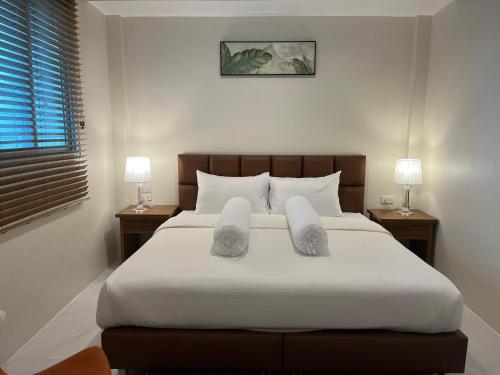 a bedroom with a large bed with towels on it at Coconut Hill Koh Chang in Khlaung Phai Bae