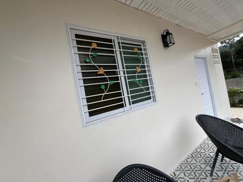 a window of a house with a christmas ornament at Coconut Hill Koh Chang in Khlaung Phai Bae