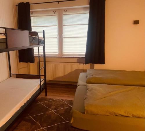 a bedroom with two bunk beds and a window at Familienapartment in Bad Orb