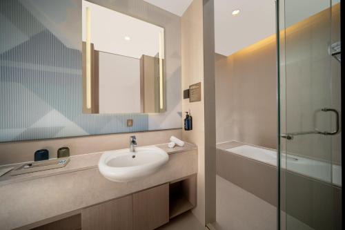a bathroom with a sink and a mirror and a shower at Holiday Inn Express Wuxi Taihu by IHG in Wuxi