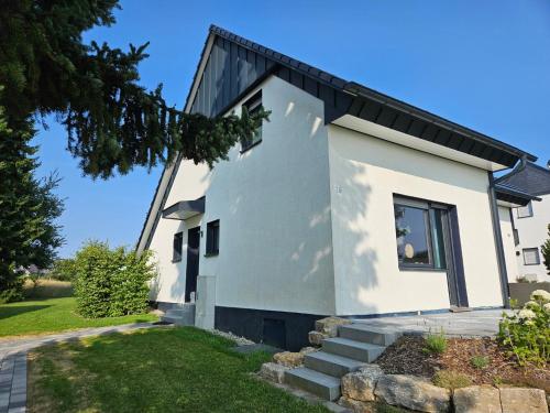 a white house with a black roof at Ferienhaus Küstelnest in Medebach