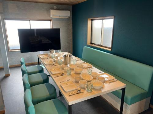 a dining room with a long table and chairs at BOTH ISUMI - Vacation STAY 06710v in Isumi
