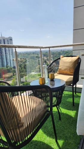 a patio with a table and chairs on a balcony at Erick Homes in Ruiru