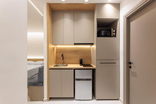 a small kitchen with a sink and a bed at Dialetti's Nook In Ελλάδα in Thessaloniki