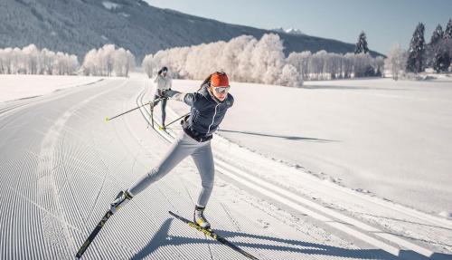 a woman is skiing down a snow covered slope at Leos Chalet in Valdaora di Sopra
