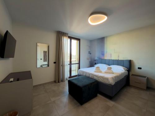 a bedroom with a bed and a stool in it at Narciso Guest House in Quarantoli