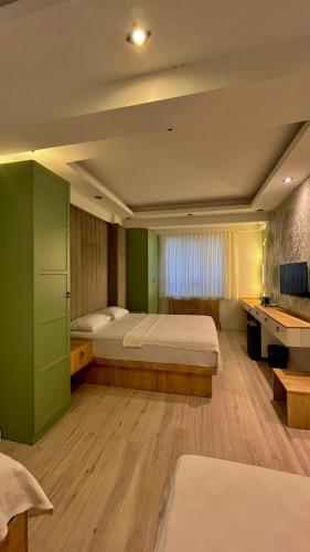 a large bedroom with two beds and a desk at Siya Boutique Hotel in Batman