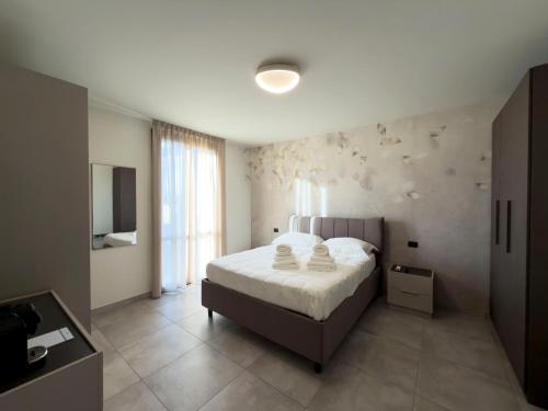 a bedroom with a bed and a television in it at Narciso Guest House in Quarantoli