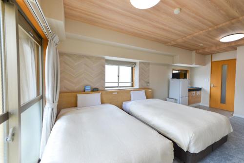 Katil atau katil-katil dalam bilik di Hotel New Gaea Yakuin