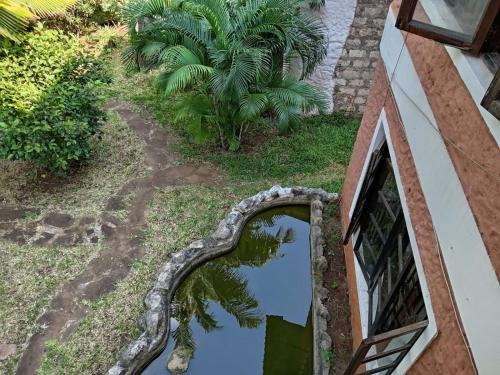 a mirror on the side of a building with a palm tree at Kk bnb in Mombasa
