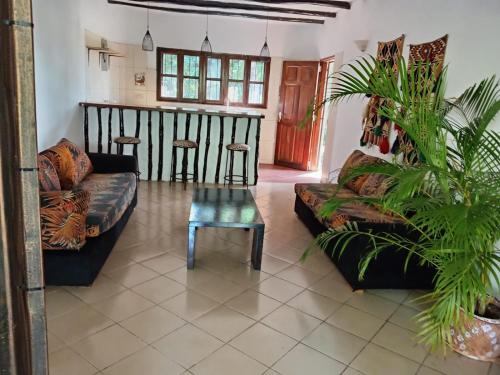 a living room with a couch and a table at Kk bnb in Mombasa