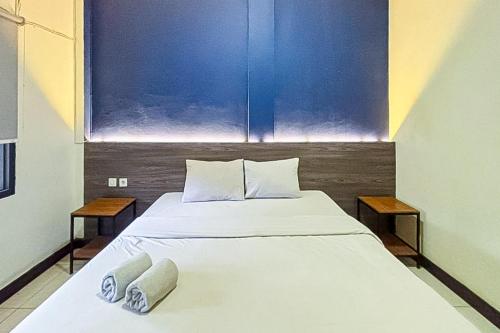a bedroom with a large bed with two pillows on it at Garden View near Batu Tulis RedPartner in Bogor