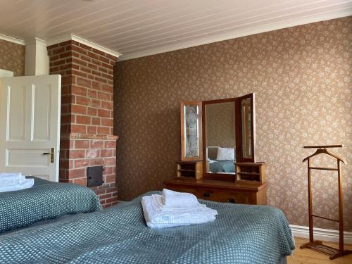 a bedroom with two beds and a mirror at Manor House - Torsberg Farm in Färgelanda