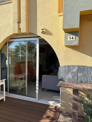an entrance to a patio with sliding glass doors at BORD DE MER in Port Leucate