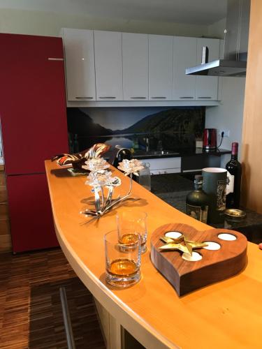 a kitchen table with glasses and a box on it at ALPENLOFT Gerlitzen in Kanzelhöhe