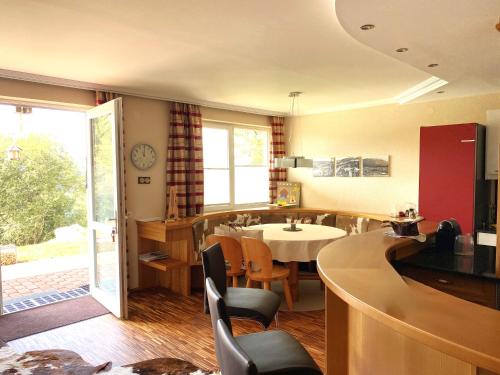 a kitchen and dining room with a table and chairs at ALPENLOFT Gerlitzen in Kanzelhöhe