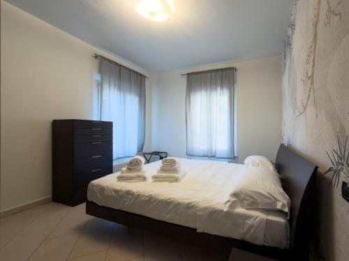 a bedroom with a bed with two towels on it at Montanari Palace in Mirandola