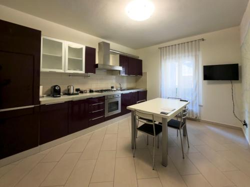 a kitchen with brown cabinets and a table with chairs at Montanari Palace in Mirandola