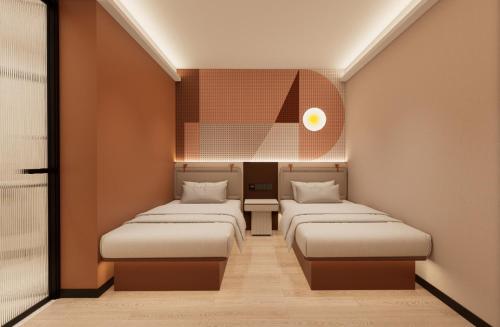 a room with three beds in a room at A Hotel Farrer Park - Newly Renovated in Singapore