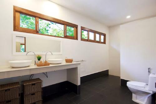 a bathroom with two sinks and a toilet at Authentic 2BR Villa in Koh Phangan in Ko Ma