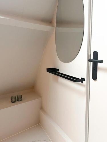 a bathroom with a mirror and some stairs at Cozy apartment in Enschede