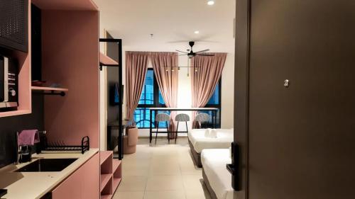 a room with a kitchen and a living room at Paxtonz Premium Suites Petaling Jaya in Petaling Jaya