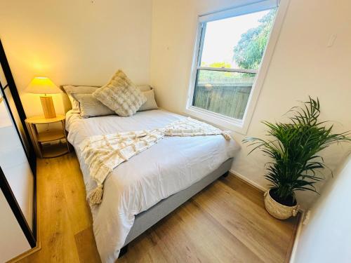 a small bedroom with a bed and a window at Affordable Luxury Stay Near Manly Beach in Sydney