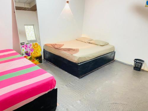 a bedroom with two beds in a room at Hotel A one - Kalawewa in Hungawila