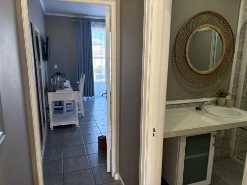 a bathroom with a sink and a mirror at Pinnacle Golf Villa 24-3 in DʼAlmeida