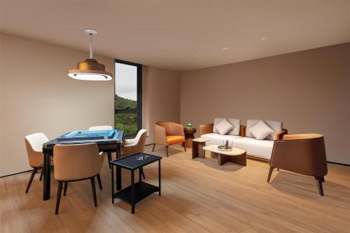 a living room with a couch and a table at Ascott Fengyishan Shenzhen in Shenzhen