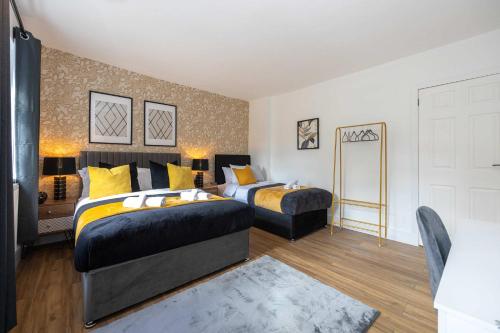 a bedroom with two beds and a mirror at Spacious Apartment near MCR Airport in Wythenshawe