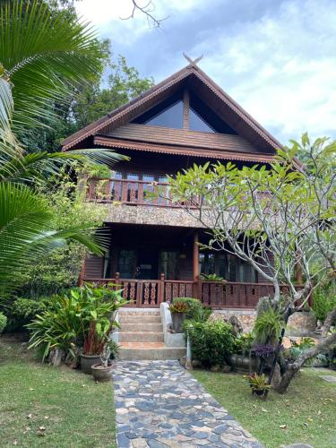 a house with stairs leading up to it at Baan Laem Noi Villa's in Mae Nam